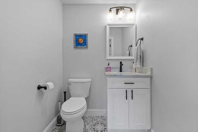 bathroom featuring toilet, tile patterned floors, and vanity