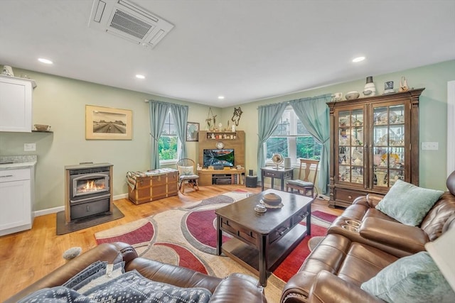 12 Cliff St, Worcester, MA 01607 - living area with a wood stove, light wood-style flooring, and recessed lighting