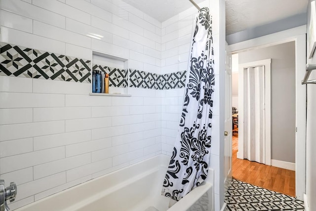 full bathroom with shower / bath combination with curtain and baseboards