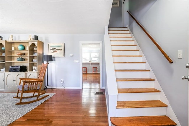 stairs with baseboards and wood finished floors