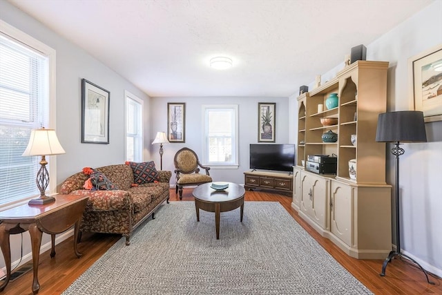 living room with wood finished floors and baseboards