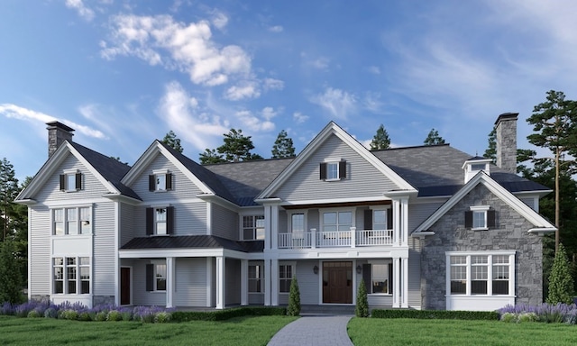 view of front facade featuring a balcony and a front yard