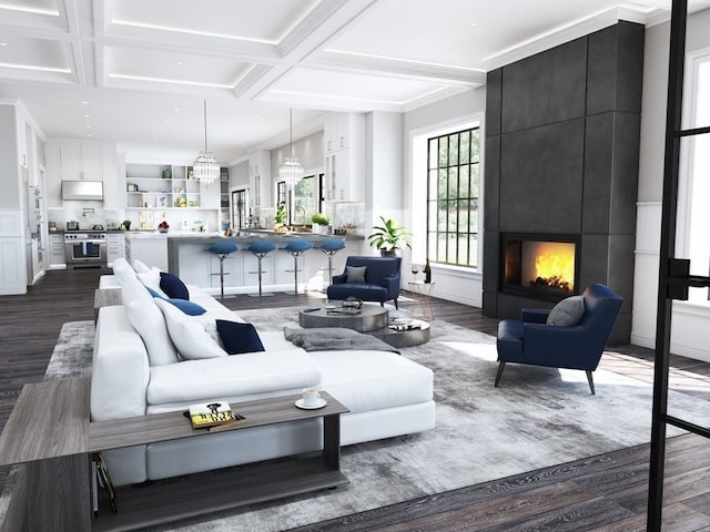 living room with coffered ceiling, an inviting chandelier, a tiled fireplace, crown molding, and dark hardwood / wood-style floors