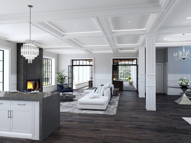 living room featuring a notable chandelier, a large fireplace, dark hardwood / wood-style floors, and coffered ceiling