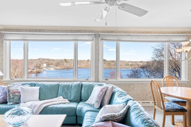 sunroom / solarium featuring a water view and ceiling fan