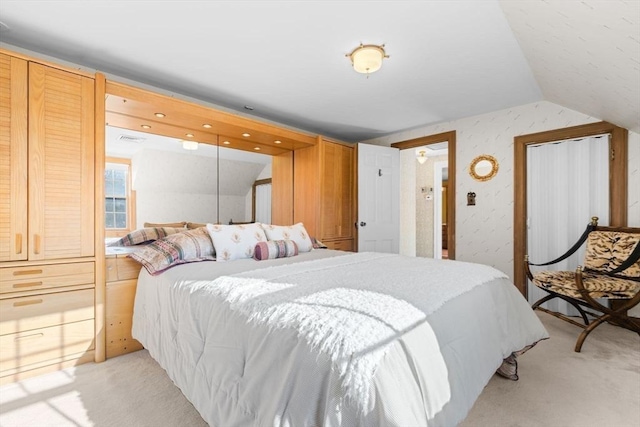 bedroom featuring lofted ceiling and light carpet