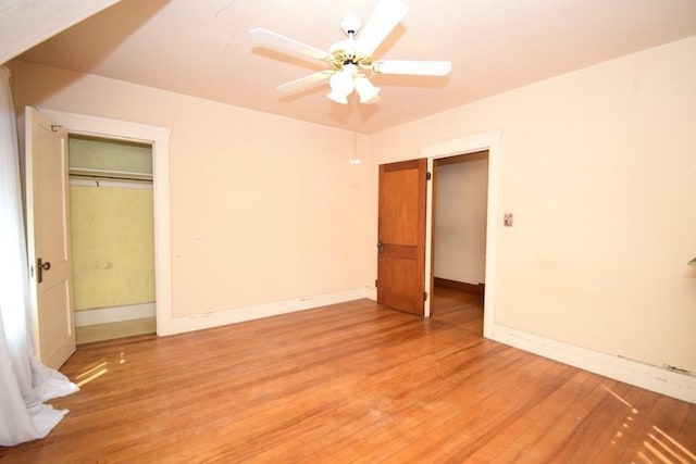 unfurnished bedroom with light wood-type flooring, baseboards, and ceiling fan