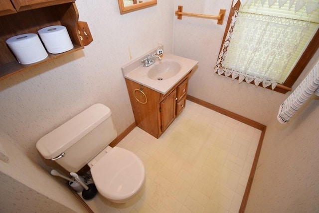 bathroom featuring tile patterned floors, vanity, and toilet
