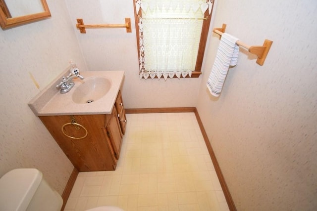 bathroom with vanity, tile patterned floors, and toilet