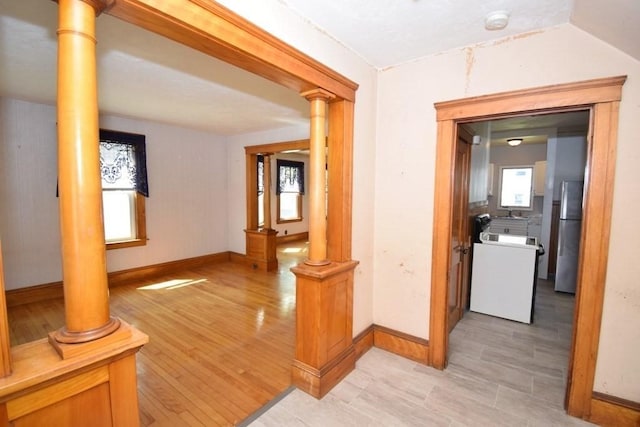 corridor with light wood-style floors and baseboards