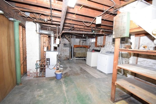 below grade area with a heating unit and independent washer and dryer