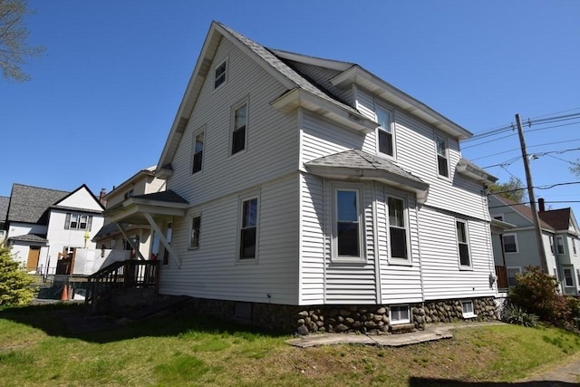 view of side of home with a yard