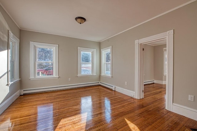 unfurnished room with hardwood / wood-style flooring, baseboard heating, and ornamental molding