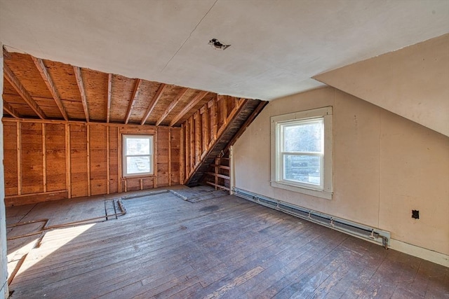 additional living space with dark hardwood / wood-style floors, lofted ceiling, and a wealth of natural light