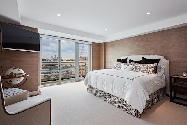 carpeted bedroom featuring access to outside and a wall of windows