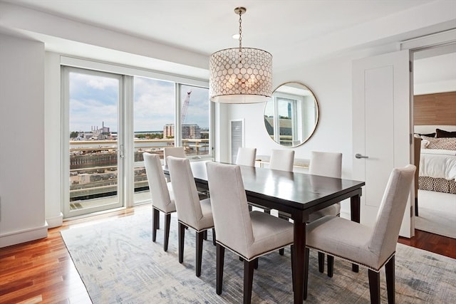 dining space with an inviting chandelier and wood-type flooring