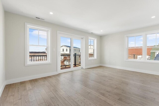 spare room with recessed lighting, baseboards, visible vents, and light wood finished floors