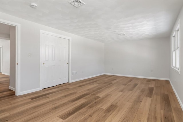 unfurnished room featuring light hardwood / wood-style floors