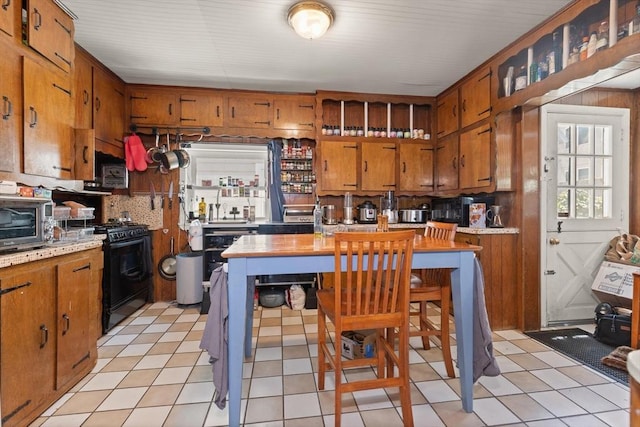 8 Peaceable St, Boston, MA 02135 - kitchen with gas stove, light countertops, brown cabinetry, and decorative backsplash