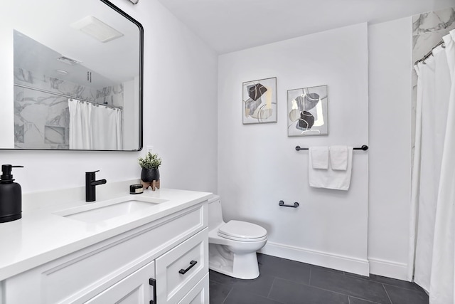 bathroom with tile patterned floors, curtained shower, vanity, and toilet