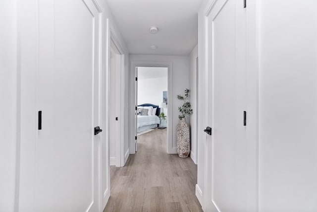 corridor with light hardwood / wood-style floors