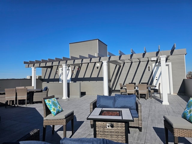 view of patio / terrace featuring an outdoor living space with a fire pit and a pergola