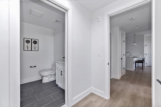 bathroom featuring wood-type flooring and toilet