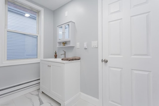 bathroom with a baseboard heating unit and sink