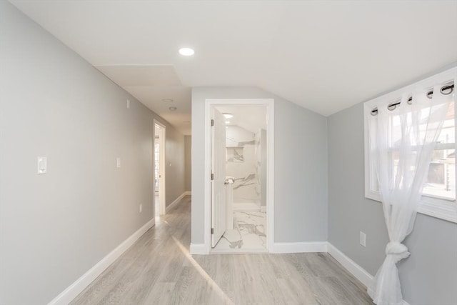 interior space featuring light hardwood / wood-style floors and lofted ceiling