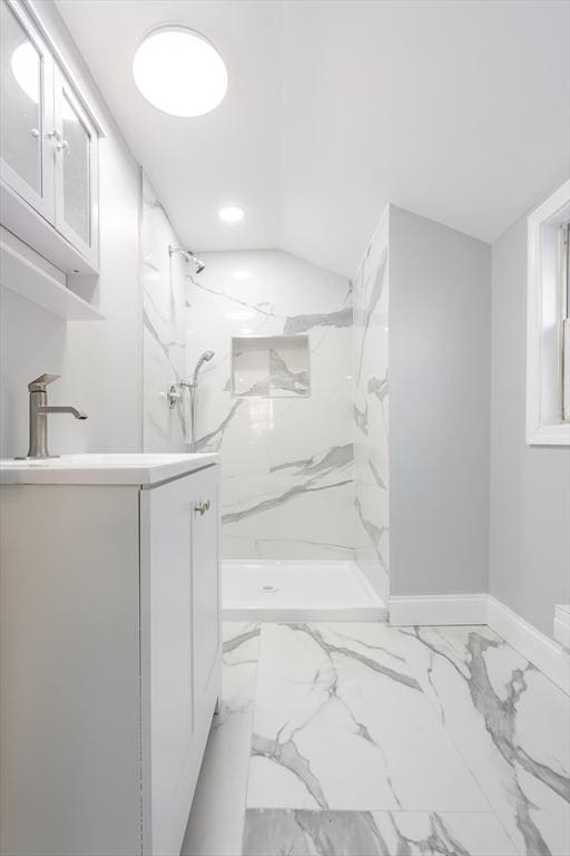 bathroom with vanity and tiled shower