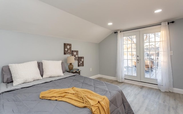 bedroom with french doors, access to outside, vaulted ceiling, and light hardwood / wood-style floors