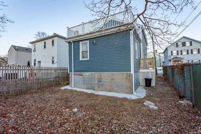 back of property featuring a balcony