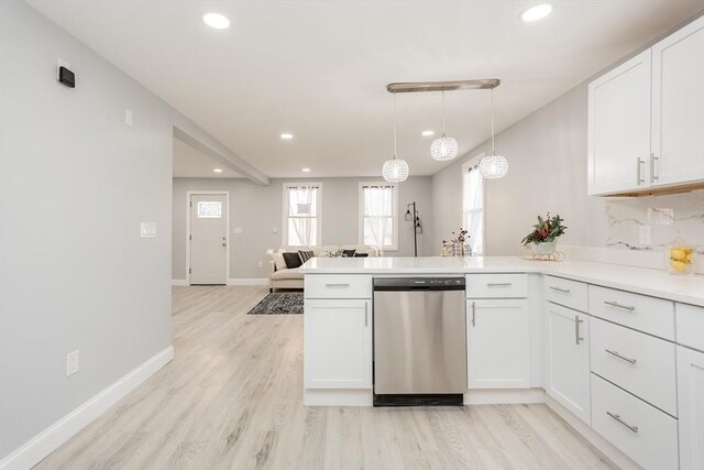 kitchen with kitchen peninsula, white cabinetry, dishwasher, and decorative light fixtures