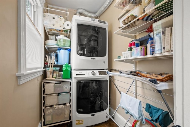 laundry area featuring stacked washer and clothes dryer