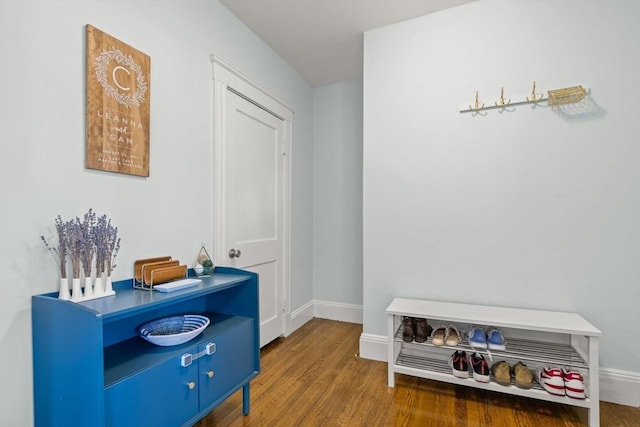 hallway with wood finished floors and baseboards