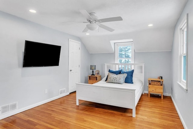 bedroom featuring ceiling fan, vaulted ceiling, and light hardwood / wood-style flooring