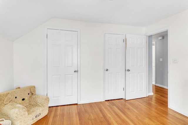 interior space with lofted ceiling and hardwood / wood-style floors