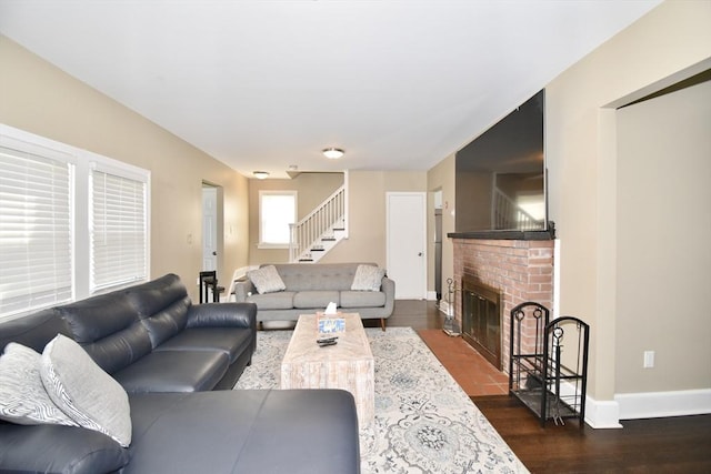 98 Osborne Ter, Springfield, MA 01104 - living area with stairs, dark wood-style flooring, baseboards, and a fireplace