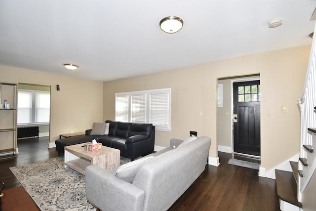 98 Osborne Ter, Springfield, MA 01104 - living room with radiator, dark wood-style floors, baseboards, and stairway