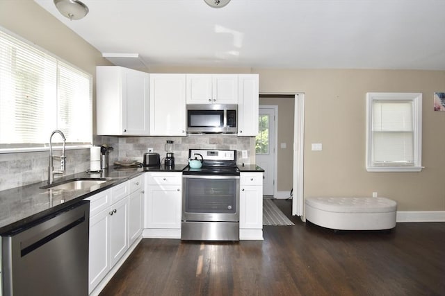 98 Osborne Ter, Springfield, MA 01104 - kitchen featuring stainless steel appliances, a sink, decorative backsplash, and dark wood finished floors