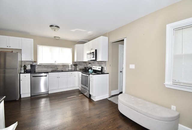 98 Osborne Ter, Springfield, MA 01104 - kitchen with appliances with stainless steel finishes, a sink, backsplash, and dark countertops