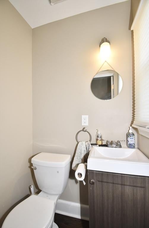 98 Osborne Ter, Springfield, MA 01104 - half bath featuring toilet, vanity, wood finished floors, and baseboards