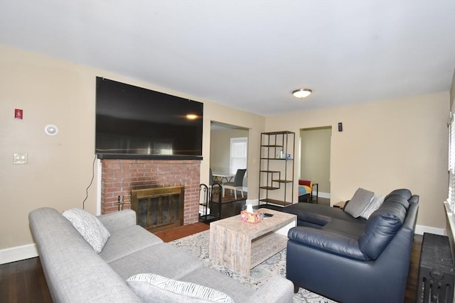 98 Osborne Ter, Springfield, MA 01104 - living area with baseboards, radiator, a fireplace, and wood finished floors