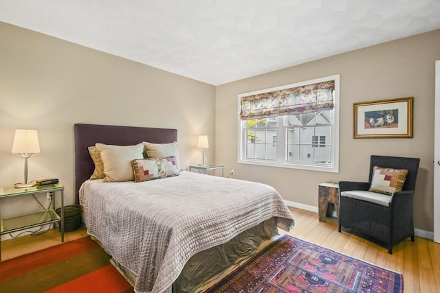 bedroom featuring wood-type flooring and baseboards
