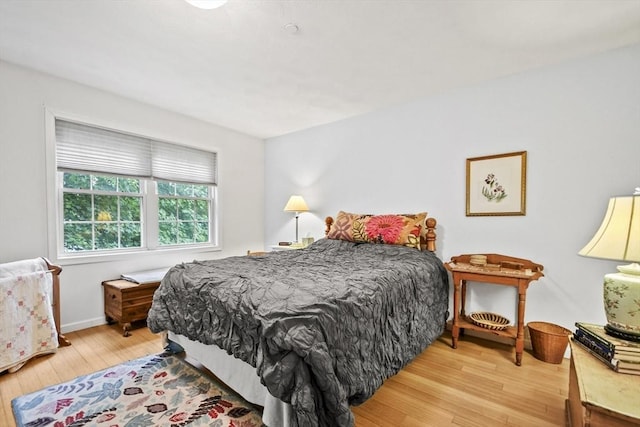 bedroom featuring wood finished floors and baseboards