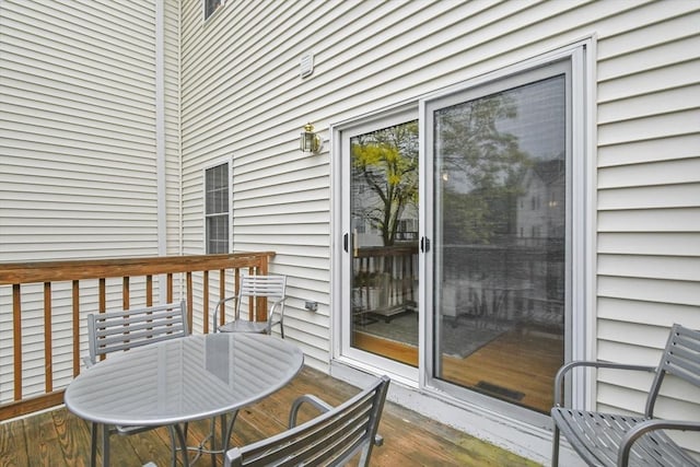 wooden deck featuring outdoor dining area