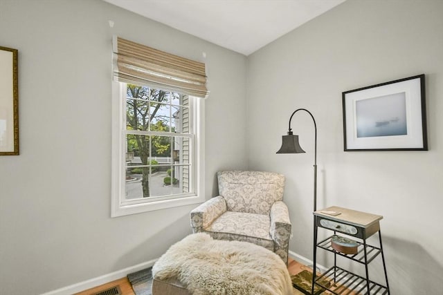 sitting room featuring baseboards and wood finished floors