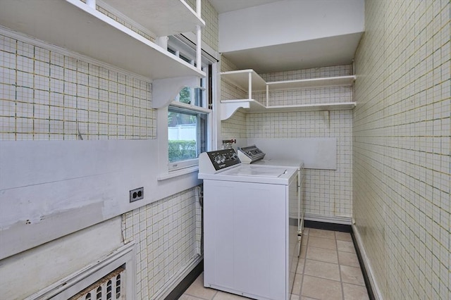 92 Dean Rd, Brookline, MA 02445 - laundry area with light tile patterned flooring, washer and dryer, and tile walls
