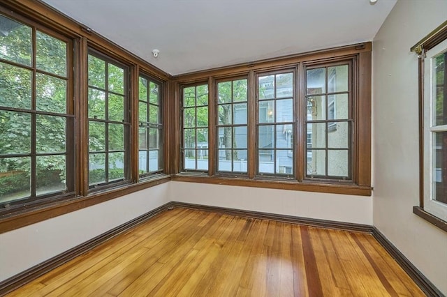 92 Dean Rd, Brookline, MA 02445 - unfurnished sunroom featuring baseboards, plenty of natural light, and hardwood / wood-style flooring