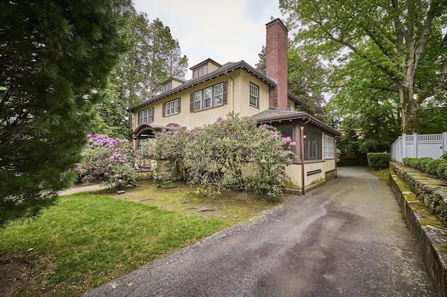 92 Dean Rd, Brookline, MA 02445 - view of front facade featuring stucco siding and a chimney